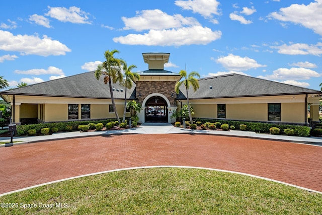 mediterranean / spanish-style home with stucco siding and stone siding