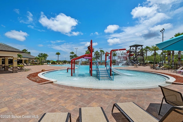 community pool featuring a water play area and a patio area