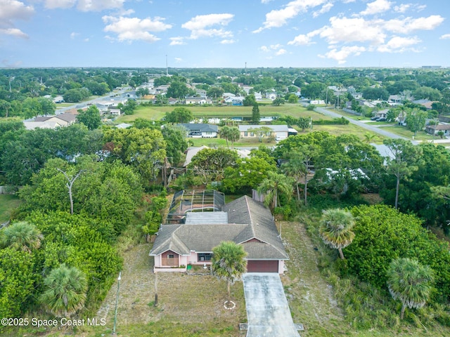 view of property location with a tree filled landscape