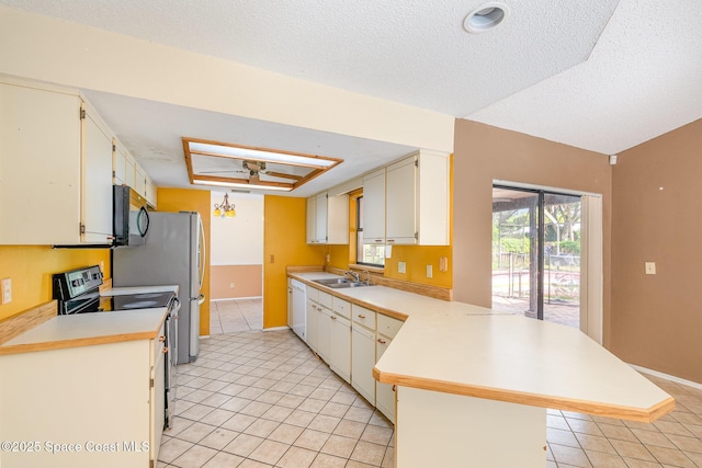 kitchen with range with electric cooktop, black microwave, a peninsula, a sink, and white dishwasher