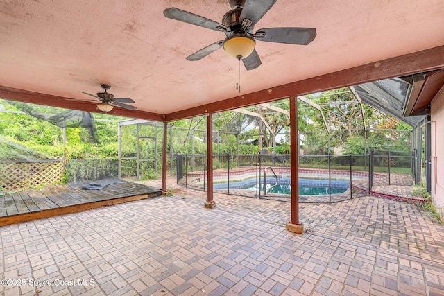 view of patio featuring a ceiling fan, a fenced backyard, and a lanai