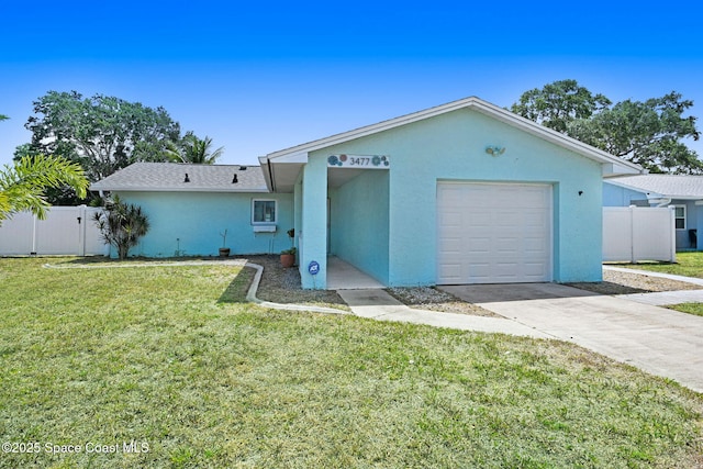 ranch-style home with an attached garage, stucco siding, a front yard, and fence