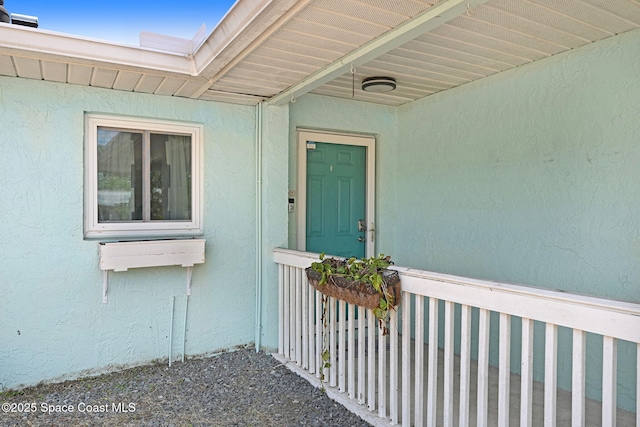 entrance to property featuring stucco siding