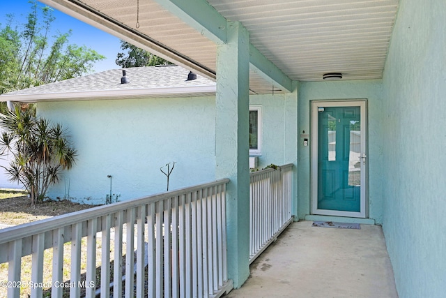 entrance to property featuring stucco siding