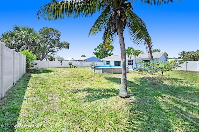 view of yard featuring a fenced in pool and a fenced backyard