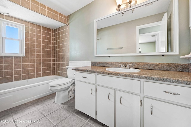 bathroom with vanity, tile patterned flooring, toilet, and shower / washtub combination