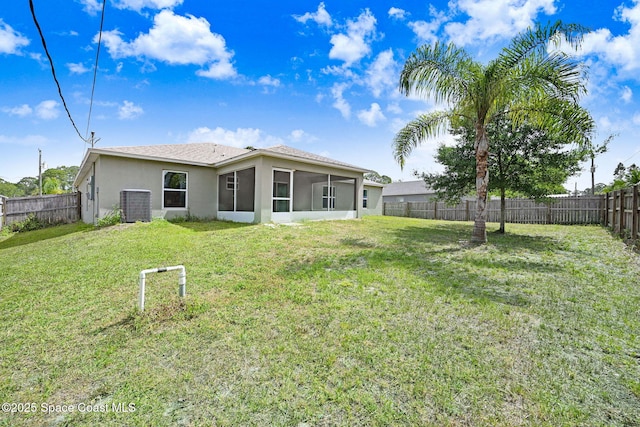 back of house with a yard, stucco siding, a fenced backyard, cooling unit, and a sunroom