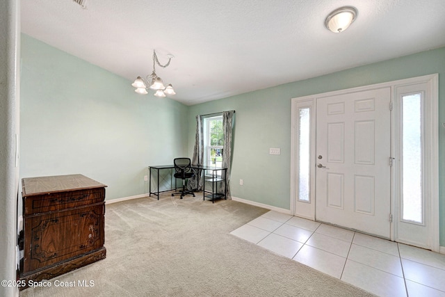 tiled foyer with baseboards, a notable chandelier, and carpet flooring