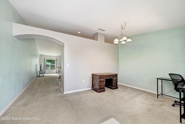 unfurnished office featuring visible vents, a chandelier, carpet floors, arched walkways, and baseboards