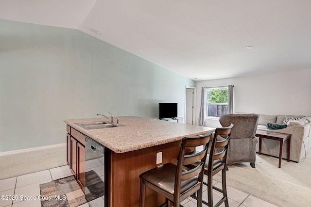 kitchen featuring a sink, lofted ceiling, dishwashing machine, light carpet, and open floor plan