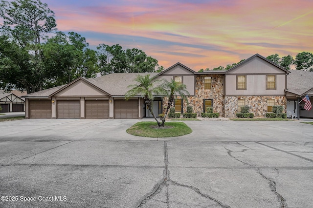 612 Saint Albans Ct Unit 19B, West Melbourne, FL 32904 - view of front facade featuring an attached garage, concrete driveway, and stone siding