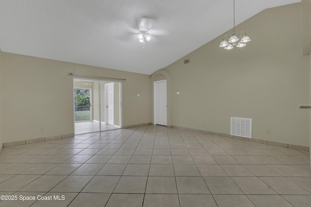 spare room with visible vents, arched walkways, vaulted ceiling, light tile patterned floors, and ceiling fan with notable chandelier