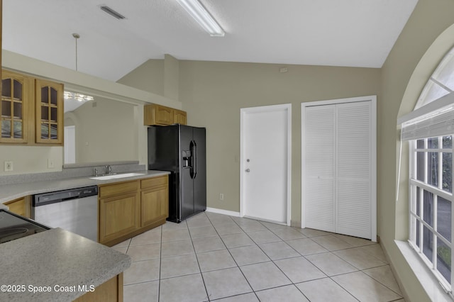 kitchen with visible vents, lofted ceiling, glass insert cabinets, a sink, and black appliances