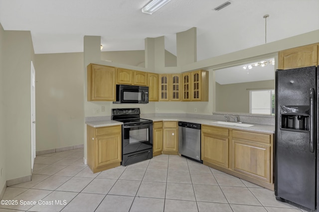 kitchen featuring visible vents, a sink, light countertops, black appliances, and glass insert cabinets