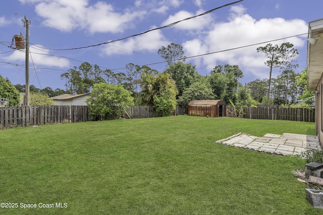 view of yard with an outdoor structure, a fenced backyard, a storage shed, and a patio