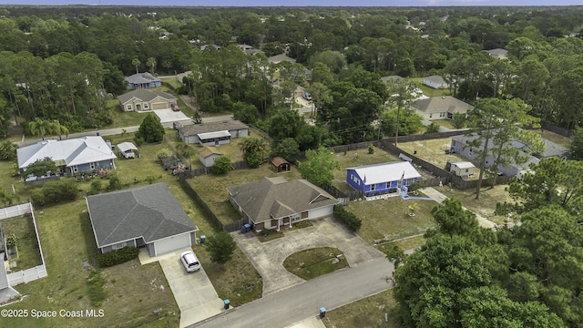 bird's eye view featuring a view of trees and a residential view