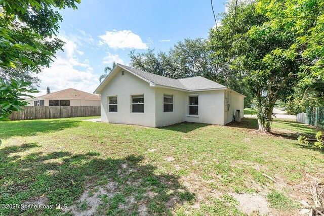1500 Gardenton St NW Unit 44, Palm Bay, FL 32907 - rear view of house with stucco siding
