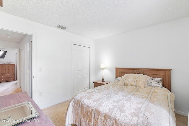 1500 Gardenton St NW Unit 44, Palm Bay, FL 32907 - bedroom featuring light colored carpet, a closet, baseboards, and a textured ceiling