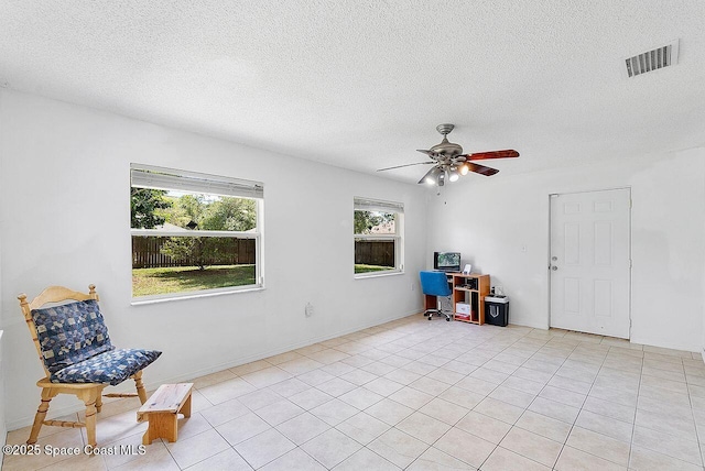 1500 Gardenton St NW Unit 44, Palm Bay, FL 32907 - interior space with ceiling fan, a textured ceiling, light tile patterned floors, and baseboards