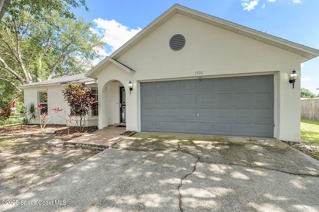 1500 Gardenton St NW Unit 44, Palm Bay, FL 32907 - view of front facade featuring stucco siding, driveway, and a garage