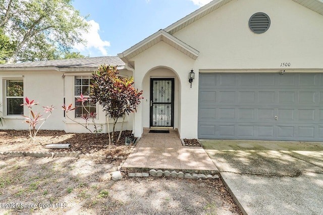 1500 Gardenton St NW Unit 44, Palm Bay, FL 32907 - view of front of property featuring stucco siding and a garage