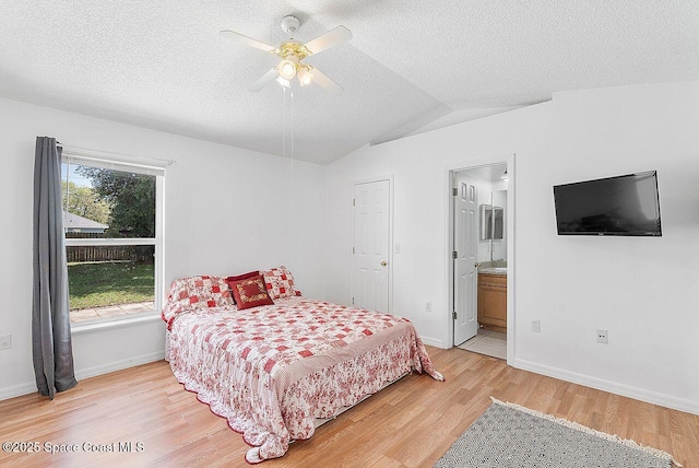 1500 Gardenton St NW Unit 44, Palm Bay, FL 32907 - bedroom with light wood-type flooring, vaulted ceiling, baseboards, a textured ceiling, and ceiling fan