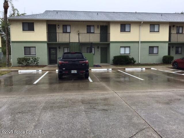 1720 Murrell Rd Unit 207, Rockledge, FL 32955 - view of property featuring uncovered parking