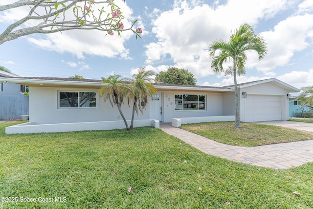 single story home with concrete driveway, an attached garage, a front yard, and stucco siding