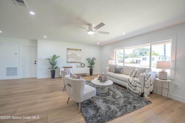 living area with visible vents, a ceiling fan, light wood finished floors, and recessed lighting