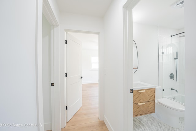 full bath with vanity, toilet, shower / washtub combination, wood finished floors, and visible vents
