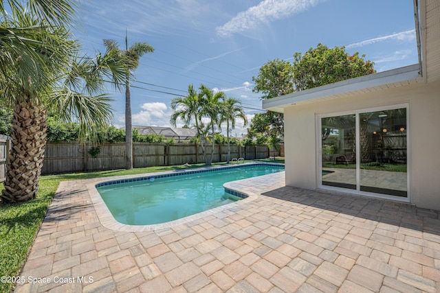 view of swimming pool featuring a patio, a fenced backyard, and a fenced in pool
