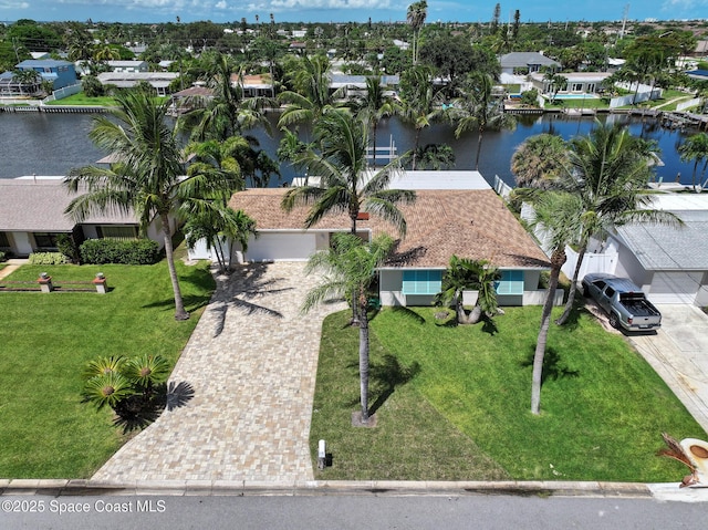 birds eye view of property featuring a water view and a residential view
