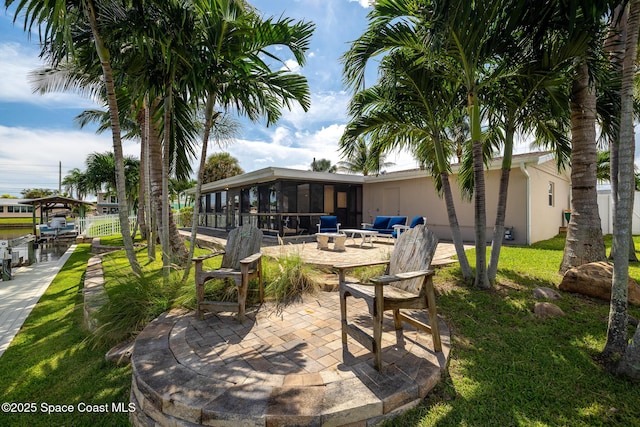 view of patio / terrace featuring a sunroom