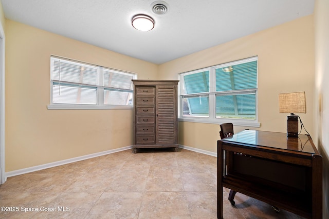 office featuring baseboards, light tile patterned flooring, and visible vents