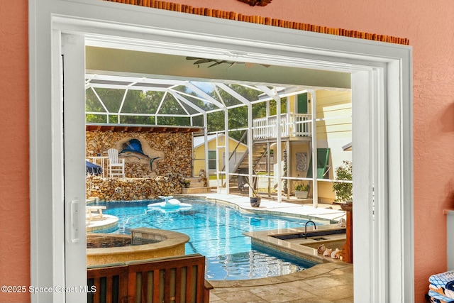 pool featuring a lanai, a hot tub, a patio, and stairs