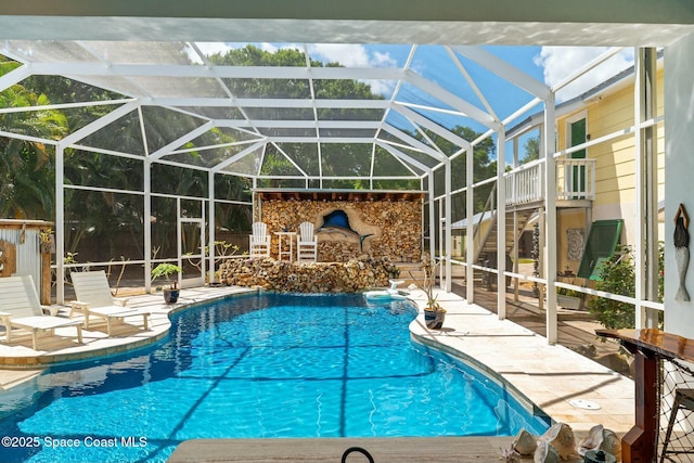 pool featuring a patio area, a lanai, and stairway