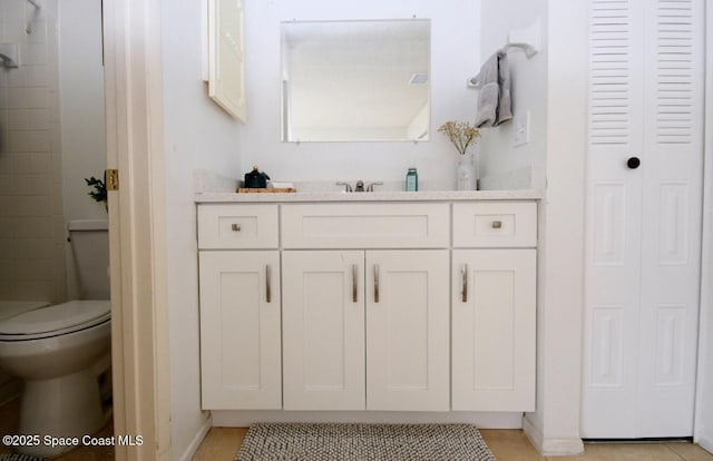 bathroom featuring vanity, tile patterned floors, baseboards, toilet, and tiled shower
