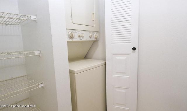 laundry room with stacked washer and dryer and laundry area