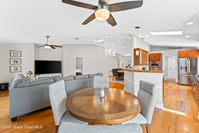 dining area featuring a ceiling fan, recessed lighting, light wood-style flooring, and lofted ceiling