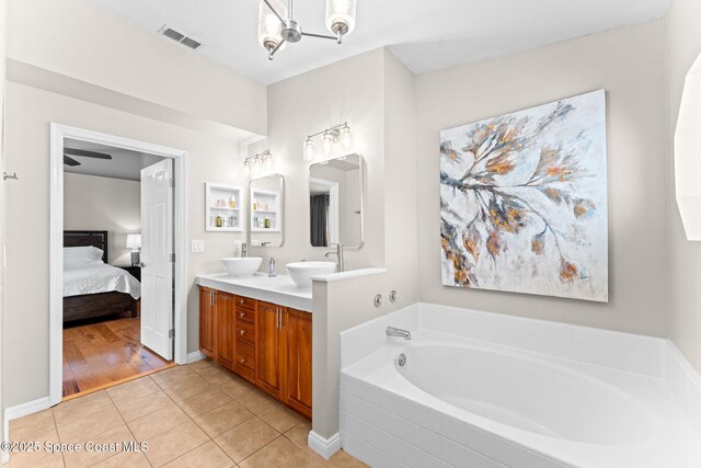 full bath featuring visible vents, tile patterned flooring, double vanity, connected bathroom, and a bath