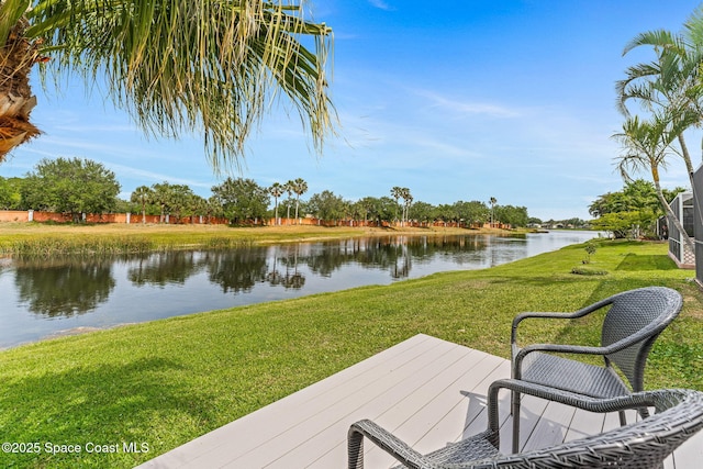 deck featuring a lawn and a water view