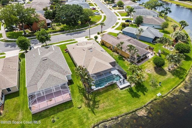 birds eye view of property with a water view and a residential view