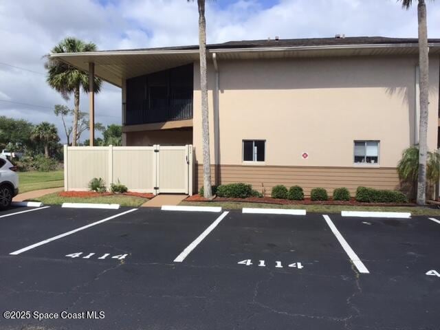 uncovered parking lot featuring a gate