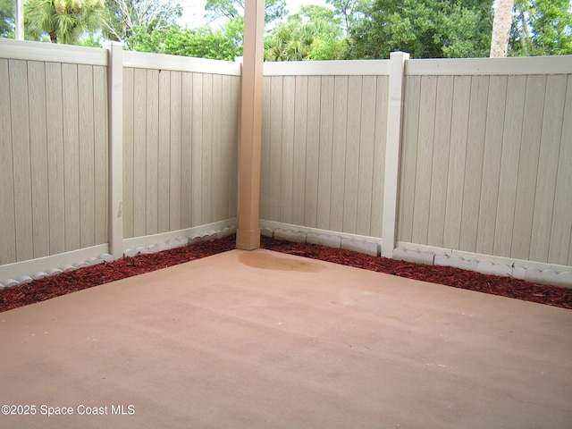 view of gate with fence and a patio