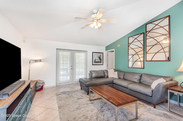 living area featuring lofted ceiling, baseboards, french doors, a ceiling fan, and light tile patterned floors
