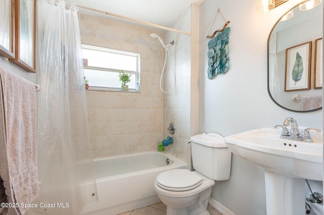 full bathroom with tile patterned flooring, shower / bath combination with curtain, toilet, baseboards, and a sink