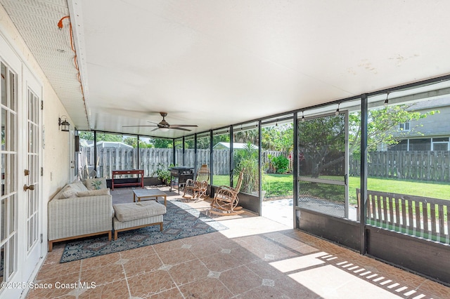 sunroom / solarium featuring a ceiling fan and french doors
