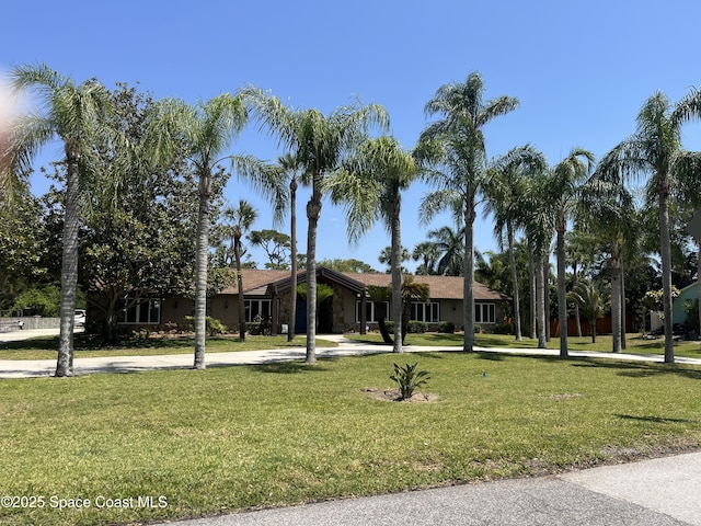 580 Hidden Creek Dr, Merritt Island, FL 32952 - ranch-style house with curved driveway and a front lawn