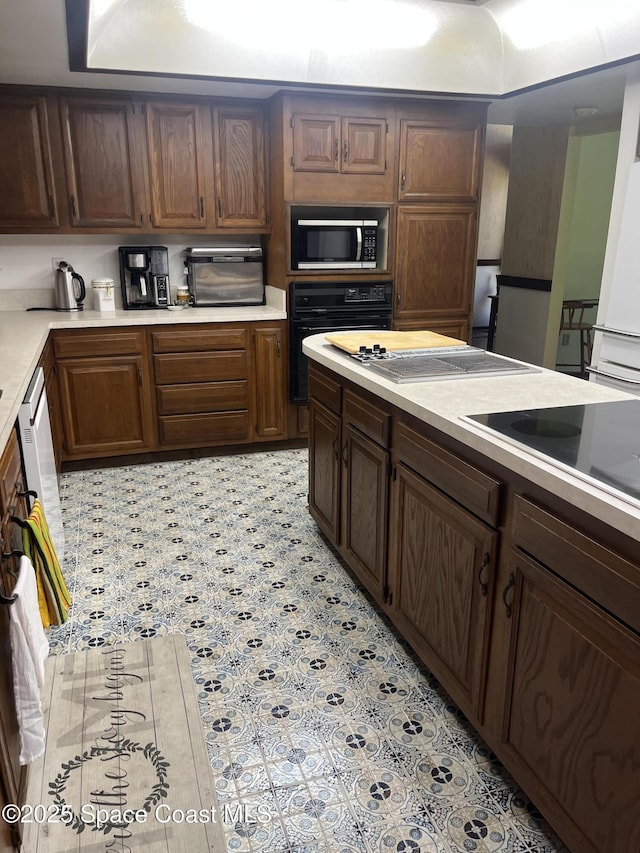 580 Hidden Creek Dr, Merritt Island, FL 32952 - kitchen with light countertops, a toaster, and black appliances