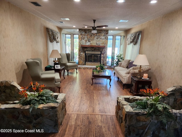 580 Hidden Creek Dr, Merritt Island, FL 32952 - living room with visible vents, wood finished floors, a fireplace, recessed lighting, and a ceiling fan